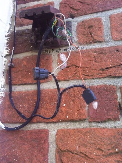 Telephone wires exposed to the weather, awaiting repair